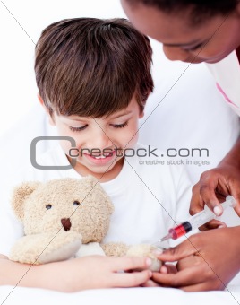 Attentive female doctor playing with a little boy 