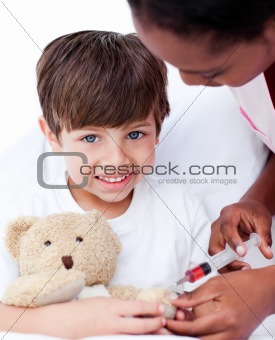 Caring female doctor playing with a little boy 