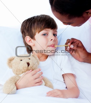 Serious nurse taking child's temperature 