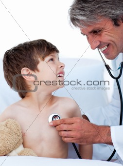 Mature male doctor checking little boy's pulse 
