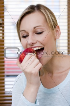 Beautiful Healthy Woman Eating an Apple