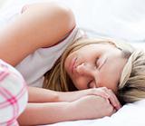 Charming young woman sleeping on a bed 