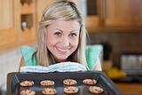 Cute young woman baking cookies