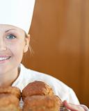 Close-up of a smiling female chef baking scones