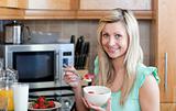 Attractive young woman having an healthy breakfast in a kitchen