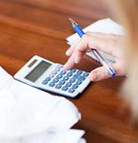 Close-up of a blond woman paying her bills 
