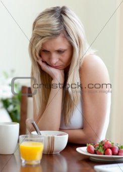 Tired woman having an healthy breakfast