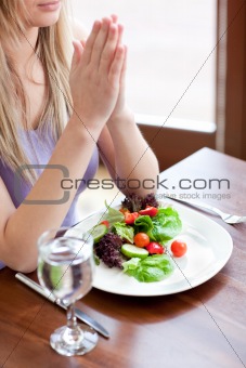 Portrait of a cute woman eating a salad 