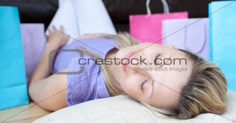Charming woman after shopping sleeping on the floor