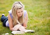 Beautiful woman reading a book in a park 