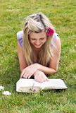 Young woman reading a book in a park 