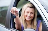 Young female driver holding a key 