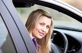 Attractive young female driver sitting in her car