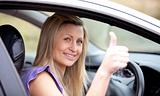 Smiling female driver with thumb up 