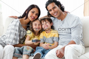 Cheerful family watching TV  together 