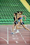 girls running on athletics race track
