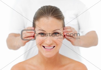 Smiling woman having a head massage in a spa