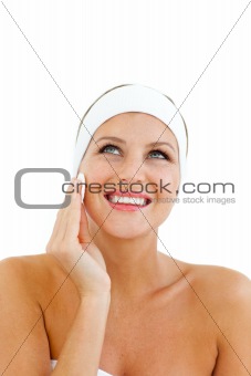 Radiant woman applying a make-up base 
