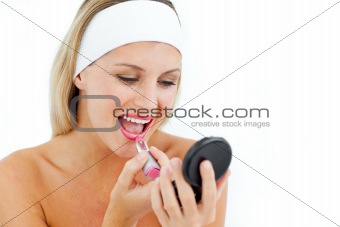 Attractive woman applying lipstick 