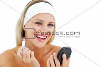 Smiling woman holding a lipstick 