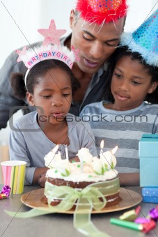 Cute little girl and her family celebrating her birthday