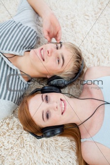 High angle of couple of teenagers listening to music 