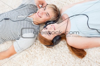 Couple of teenagers listening to music 
