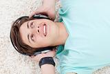 Cute teen guy listening to music with headphones