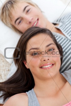 Teen lovers lying on the floor