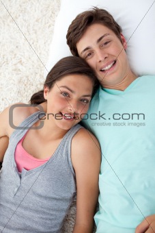 Couple of teenagers lying on the floor