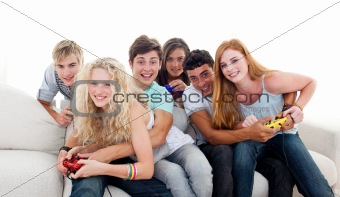 Teenagers playing video games in the living-room
