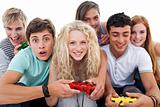 Excited teenagers playing video games in the living-room