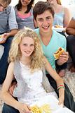 Teenagers eating burgers and fries