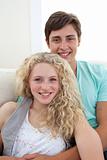 Portrait of teens couple sitting on the sofa