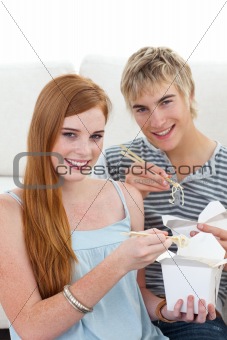 Couple of friends eating pasta