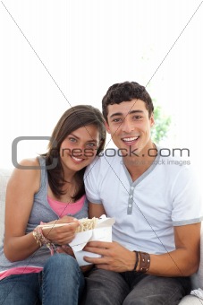 Couple of teenagers eating pasta with copy-space