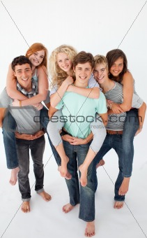 Teenagers giving their friends piggyback rides