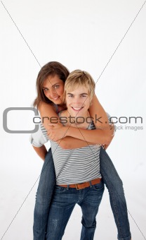 Teen guy giving a friend piggyback ride
