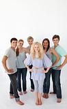 Group of friends standing against white background with copy-spa