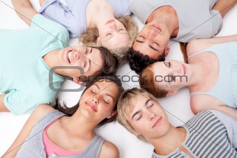Friends with their heads together sleeping on the ground