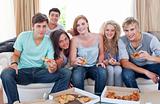 Happy adolescents eating pizza