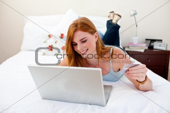 Young girl using a laptop and shopping online