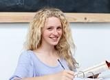 Smiling blonde teenager doing homework
