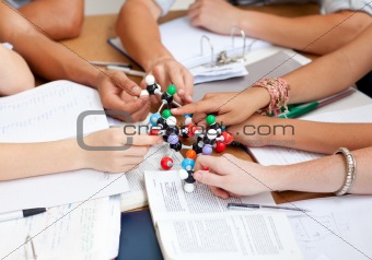 Close-up of teenagers studying molecules in a library