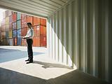 business man with shipping containers