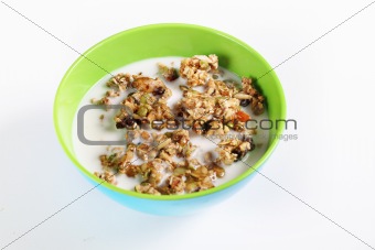shot of granola cereal with milk on white