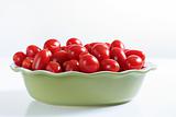 shot of grape tomatoes in a bowl on white