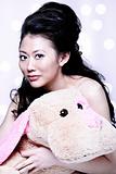 Sexy Asian female holding a stuff animal