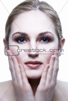 pretty female head shot with hands on face