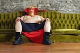 Mexican wrestler sitting on a couch